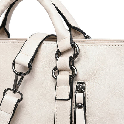 Cremeweiße strukturierte PU-Leder-Handtasche mit schwarzen Kanten, Gunmetal-Hardware und abnehmbarem Schulterriemen Nahaufnahme